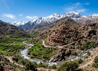 Best Day Trips from Marrakech: High Atlas Mountains, Essaouira, Agafay Desert & Ouzoud Falls High Atlas Mountains landscape with Berber village, terraced fields, and snow-capped peaks