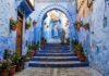 Chefchaouen Travel Guide: The Complete Blue City Planning Guide Blue-washed cobblestone alleyway with painted steps and flower pots in Chefchaouen Morocco