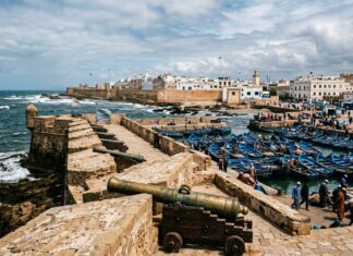 Essaouira Travel Guide: The Complete Coastal Wind & Ramparts Guide Essaouira stone ramparts and blue fishing boats in the Atlantic harbor