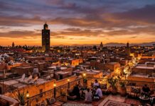How Many Days in Marrakech? Realistic 2, 3, and 4-Day Itineraries & Season Guide Sunset panoramic view over Marrakech rooftops with illuminated Koutoubia Mosque