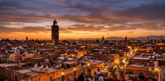How Many Days in Marrakech? Realistic 2, 3, and 4-Day Itineraries & Season Guide Sunset panoramic view over Marrakech rooftops with illuminated Koutoubia Mosque