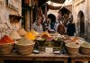 Moroccan Food Guide: What to Eat, Street Food Rules & Dining Culture Traditional Moroccan spice stall in medina alley with paprika and cumin