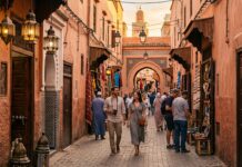 How to Avoid Scams in Marrakech: A Complete Safety & Fraud Prevention Guide Tourists walking safely through Marrakech medina terracotta alley at golden hour