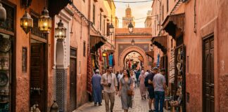 How to Avoid Scams in Marrakech: A Complete Safety & Fraud Prevention Guide Tourists walking safely through Marrakech medina terracotta alley at golden hour
