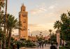 Marrakech Travel Guide: Complete First-Timer’s Planning Guide Koutoubia Mosque minaret in Marrakech Morocco framed by palm trees and Atlas mountains at sunset