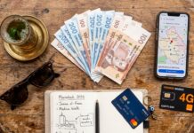 Marrakech Travel Practicalities: SIM Cards, Money, Health & Safety Travel essentials flatlay with Moroccan Dirhams banknotes, smartphone map, and Orange SIM card