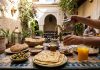 30 Moroccan Foods You Need to Try: The Ultimate Medina Eating Checklist Moroccan breakfast spread in riad courtyard with mint tea and flatbread
