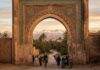 How to Travel to Morocco: The Complete Step-by-Step Guide for First-Timers (2026) Travel to Morocco: Gateway arch framing palm trees and snow-capped Atlas Mountains