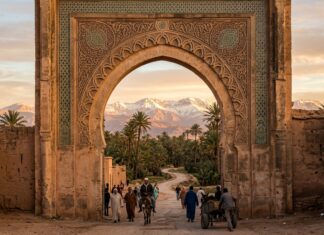 How to Travel to Morocco: The Complete Step-by-Step Guide for First-Timers (2026) Travel to Morocco: Gateway arch framing palm trees and snow-capped Atlas Mountains