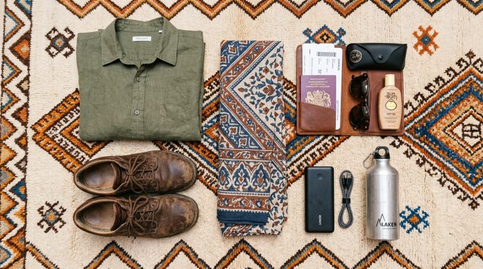 What to Pack for Morocco - Essential Travel Gear Flatlay Flatlay of essential travel packing items for Morocco on a Berber rug