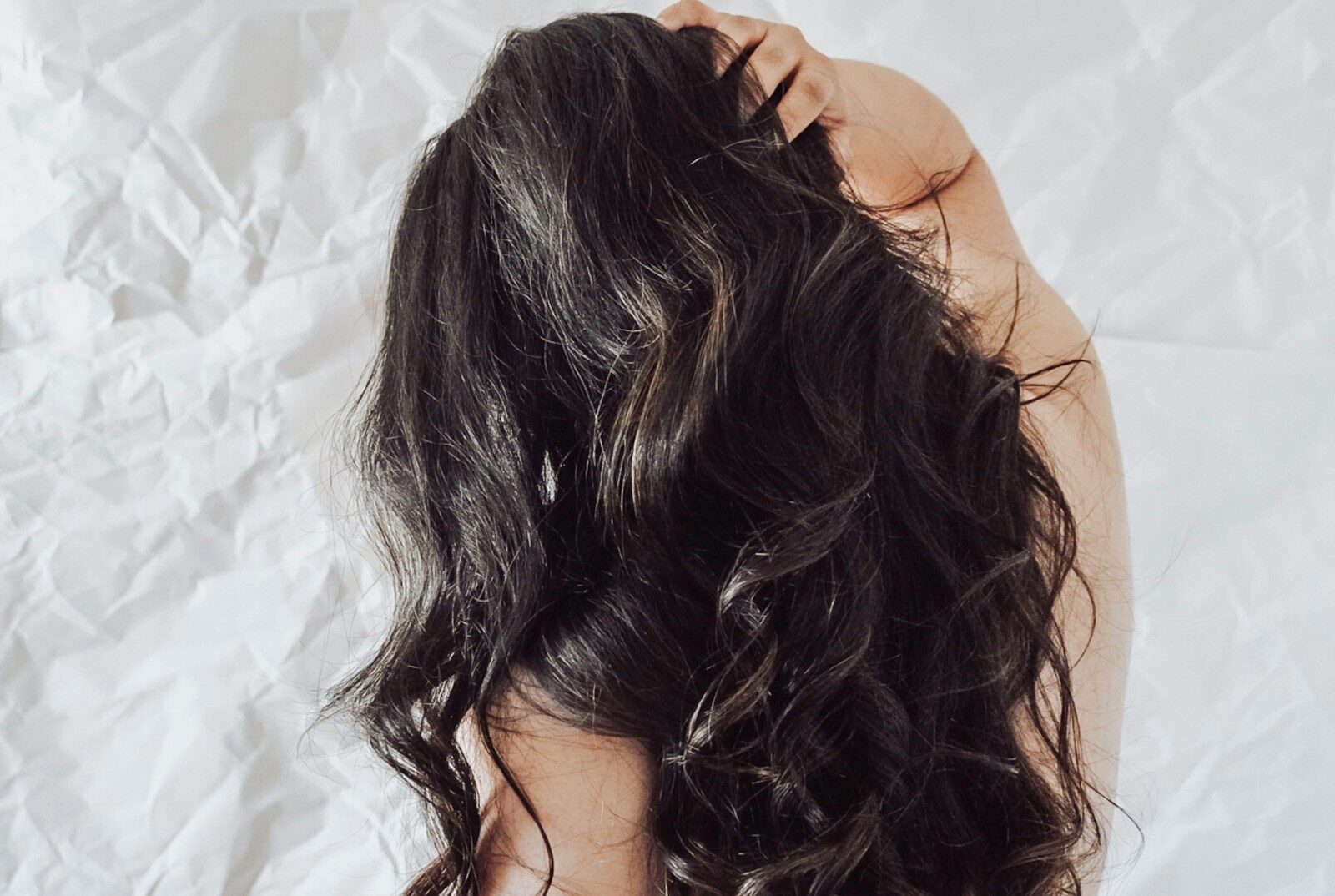 Long dark hair, the type that benefits from argan oil for hair as a leave-in