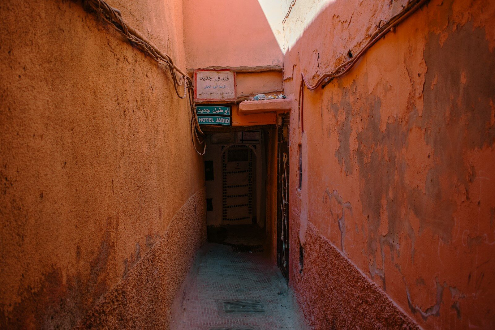 Best places to see in Casablanca: a narrow medina alleyway leading to a dark door