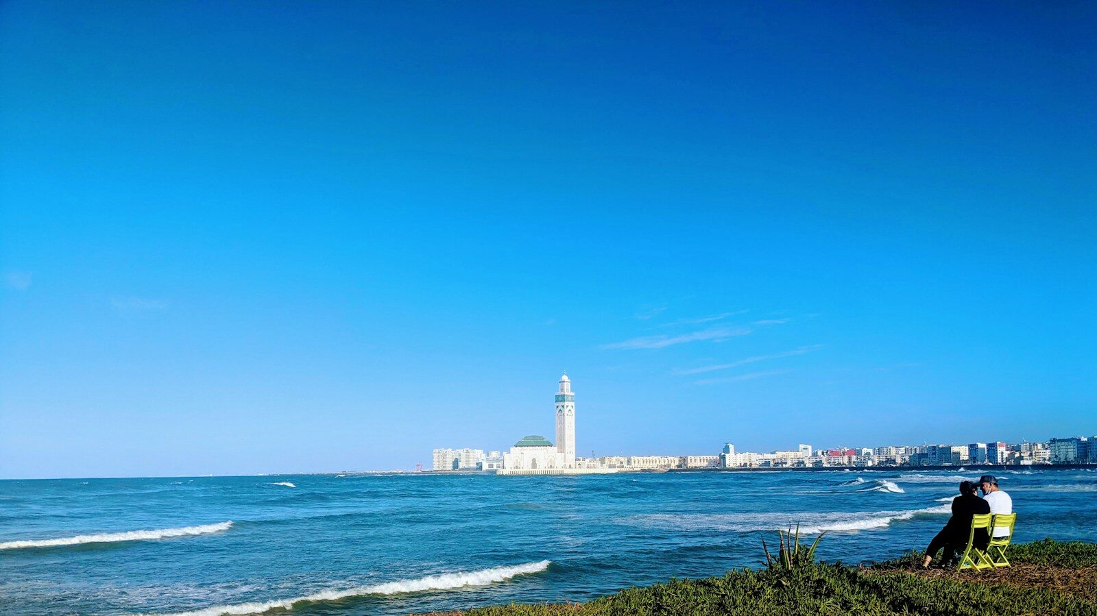 Casablanca trip: a white lighthouse beside the water on a sunny day