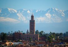 Moroccan Marrakech Guide: 10 Must-See Sights, Riads, Costs and Safety Moroccan Marrakech skyline with the Koutoubia minaret and the snow-capped Atlas Mountains
