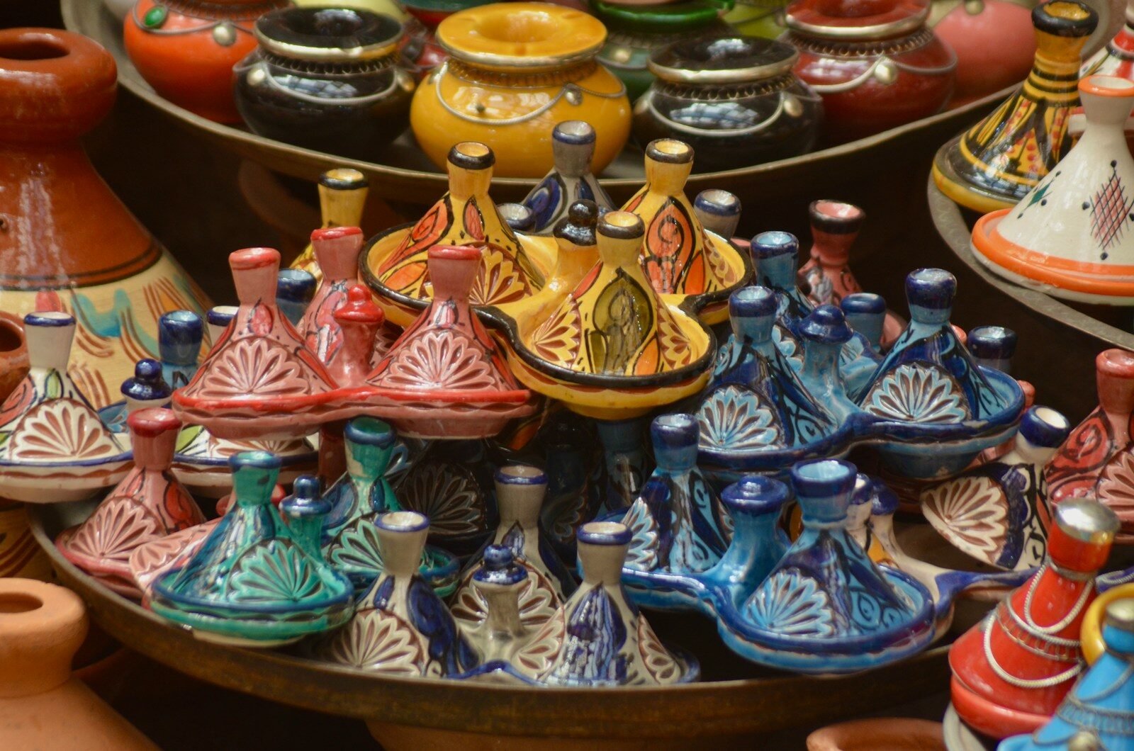 Colorful tagines on display in a Moroccan souk shop