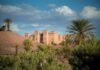 Morocco Travel Guide: Where It Is, What to Do and How Many Days You Need Morocco vacation route past an earthen kasbah and palm trees in the south