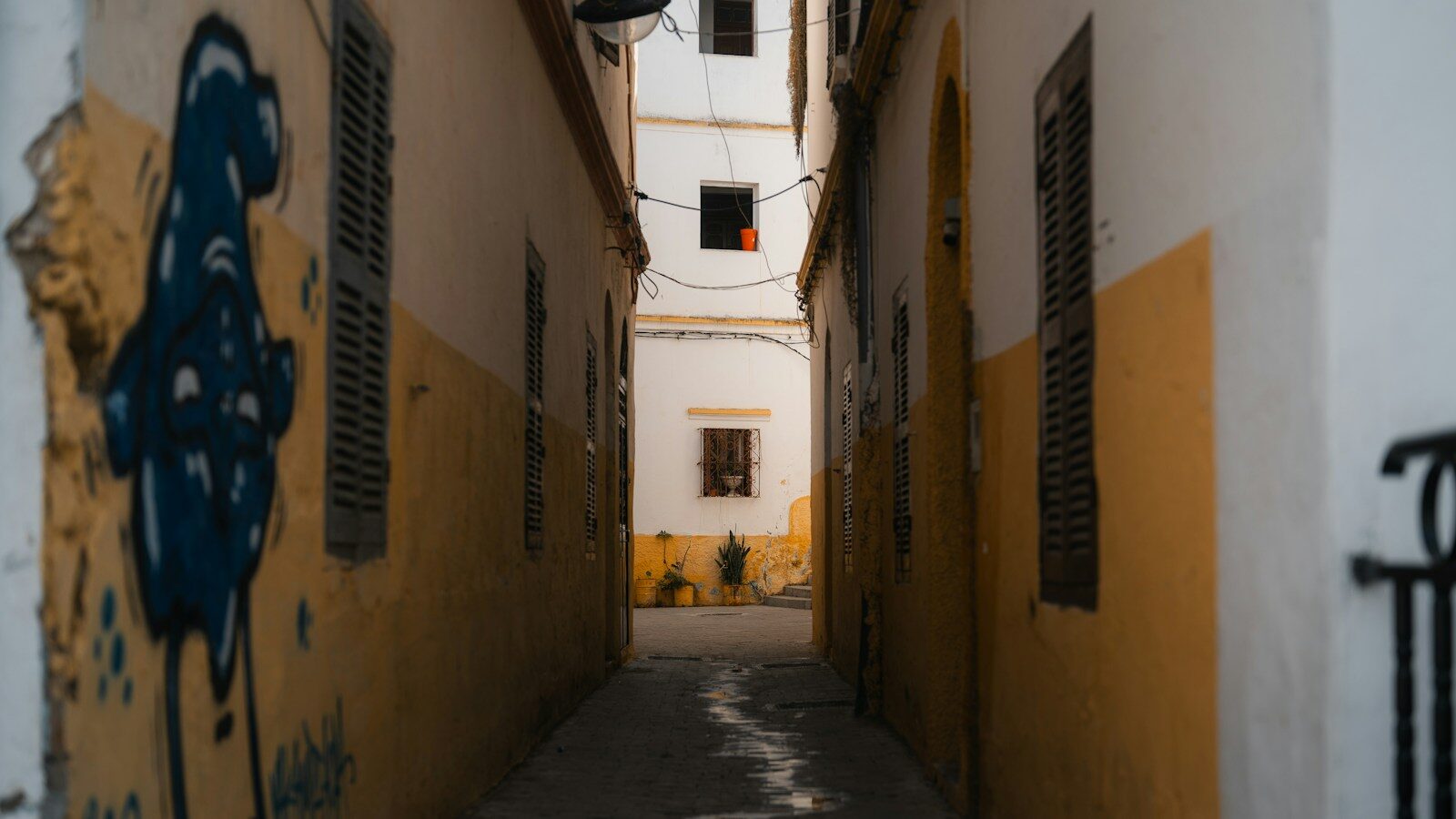 Narrow medina alley with colorful walls in the old city Tangier