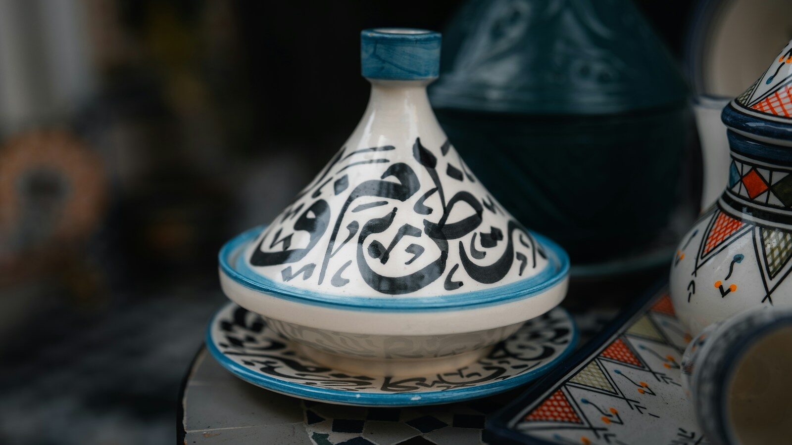 A ceramic tagine with Arabic calligraphy, a food highlight among things to do in Tangier Morocco
